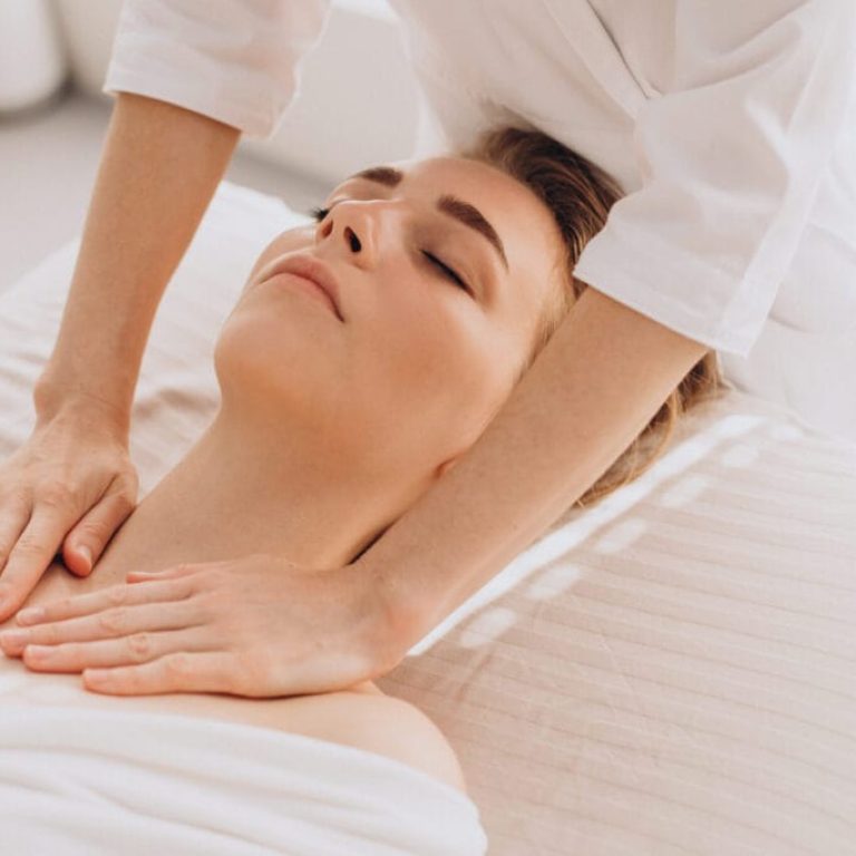 Woman in a beauty salon having face and neck massage